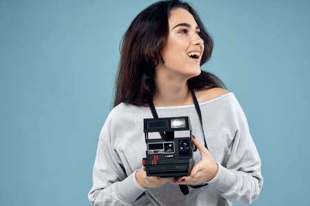 woman photographer with camera professional technology blue backgroundの写真素材