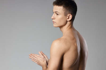 strong athlete with bulging arm muscles naked back back viewの写真素材