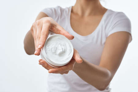 woman with cream in hands cosmetics hand skin care closeup