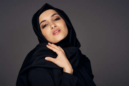 muslim woman in black hijab religion dark backgroundの写真素材