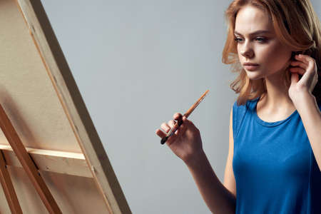 woman artist painting on easel art learning creativeの写真素材