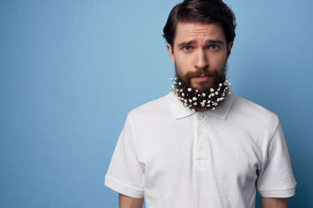 handsome man in a white shirt flowers in a beard ecology barbershopの写真素材