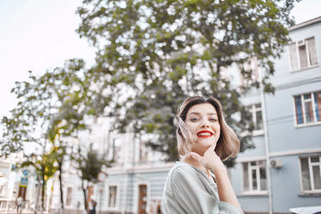 cute blonde red lips summer outdoors near treeの写真素材