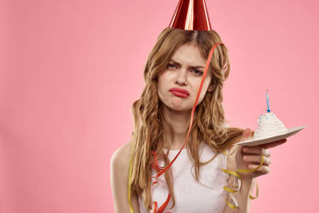 disgruntled woman birthday celebration cake party pink background