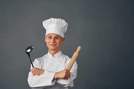 chef holding a rolling pin in his hands cooking professionals