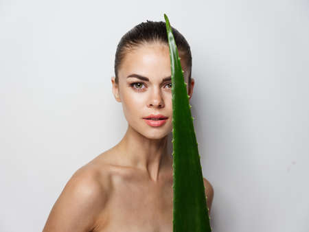 pretty woman bare shoulders clear skin aloe leaf natural lookの写真素材