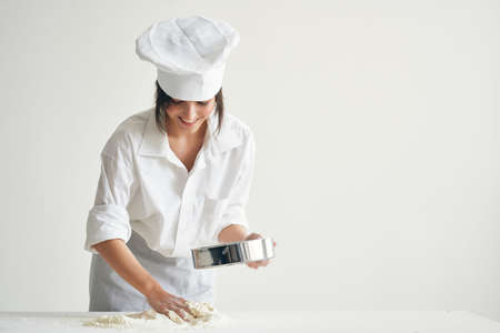 woman chef kneading dough working with flour Professionalの写真素材
