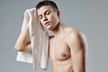 athletic guy with pumped up body wiping sweat from face workout fitness isolated backgroundの写真素材