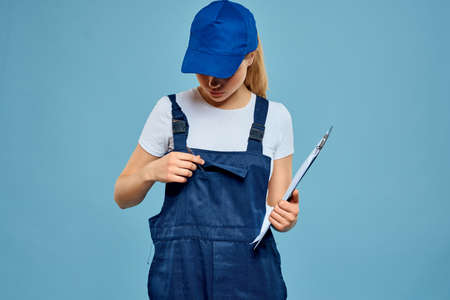 woman in construction uniform blue service professional capの写真素材
