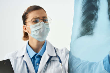 female doctor medical mask white coat work professional hospitalの写真素材