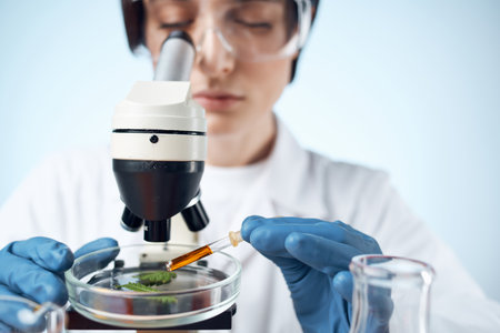 woman in laboratory adjusts microscope research analyzes technologyの写真素材