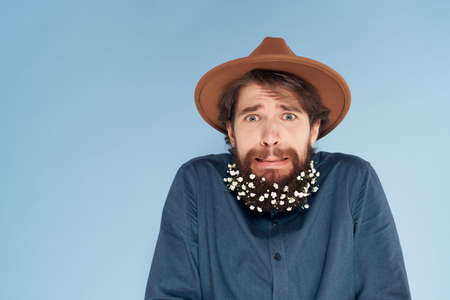 man with surprised expression wearing hat studio decoration hair careの写真素材