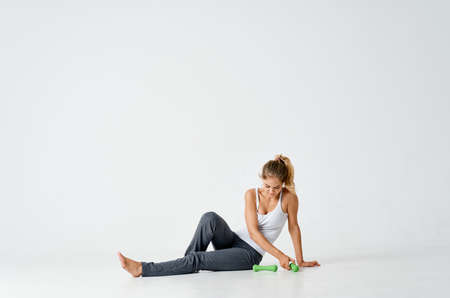 woman with dumbbells sitting on the floor exercise motivation workoutの写真素材