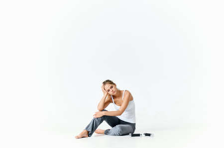 athletic woman sitting on the floor dumbbells workout motivation energyの写真素材