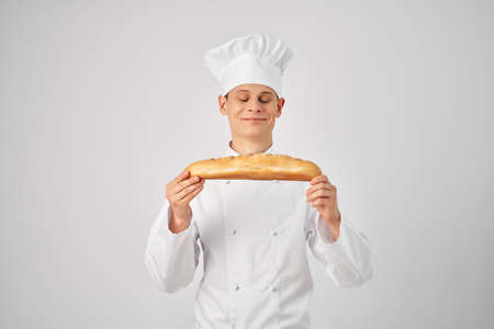 male chef with a baguette in his hands fresh product professional workの写真素材