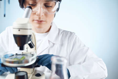 woman laboratory assistant microscope diagnostics research microbiologyの写真素材