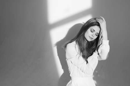 pretty woman in dress black and white photo posing studio