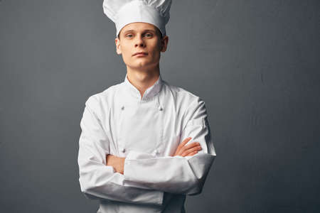 male chef in a white cap holds his hands in front of him self-confidence professionalsの写真素材
