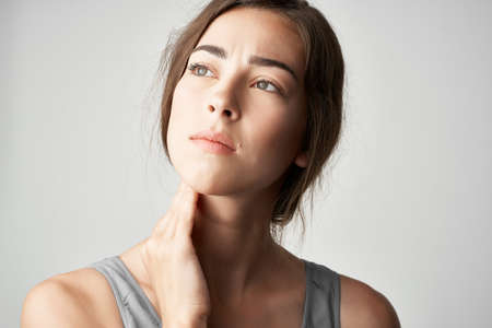 woman in t shirt neck pain health problems discomfort
