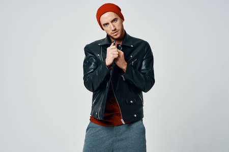 cute fashion men in red hat leather jacket posing modern style