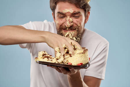 man holding cake smeared face birthday celebration funの写真素材