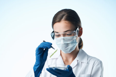 woman laboratory assistant medical mask research chemistry close-upの写真素材