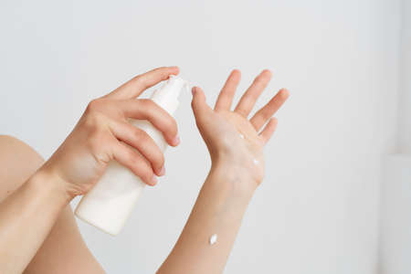 woman wear lotion burrow close-up clean skinの写真素材