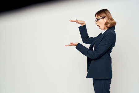 woman in suit gesturing with hand official businesswoman office workの写真素材
