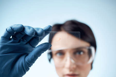 woman with blue gloves test research analysis diagnosticsの写真素材