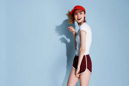 cheerful fashionable woman in summer clothes studio glamor blue backgroundの写真素材