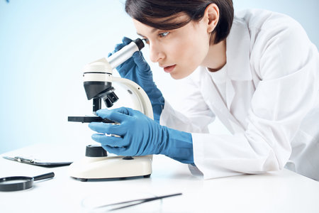 female laboratory assistant microscope research biotechnology nothingの写真素材