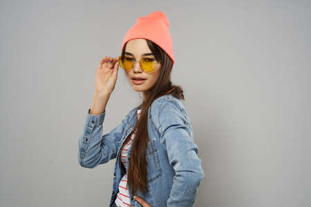 pretty woman yellow glasses pink hat studio fashion trendの写真素材
