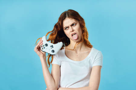 cheerful woman in a white t-shirt with a joystick in her hands video games entertainment