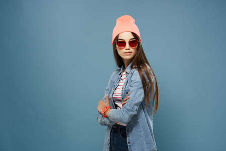 pretty woman in denim jacket pink hat glasses fashion modern styleの写真素材