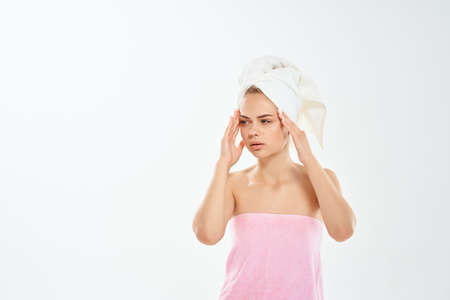 woman with a towel on her head skin care face dermatology hygieneの写真素材