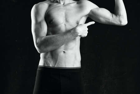 muscular man in black shorts gym black and white photo