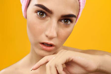 woman with drawn swords with a towel on her head face close upの写真素材