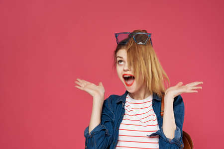 cheerful woman with backpack fashion emotions pink backgroundの写真素材