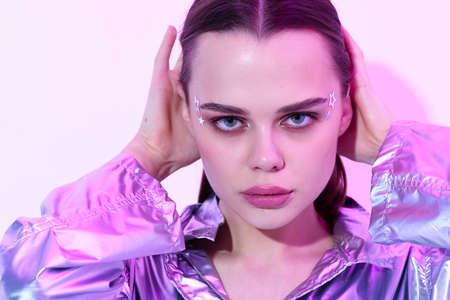 pretty woman bright makeup silver jacket posing modern styleの写真素材