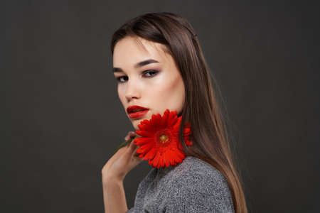 pretty woman with bright makeup red flower near face glamor