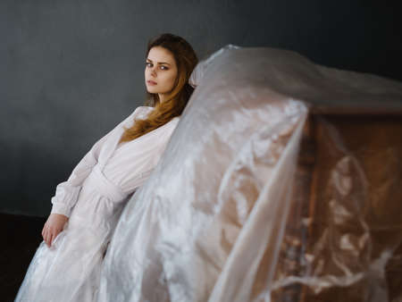 woman near piano in white dress posing romanceの写真素材
