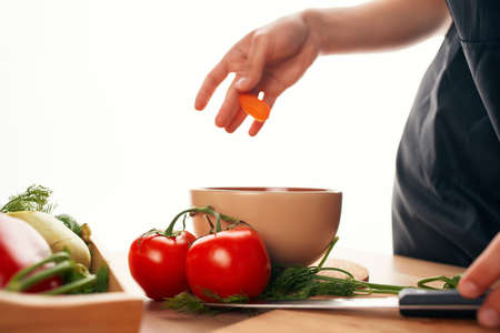slicing carrots on a cutting board kitchen cooking vegetarianismの写真素材
