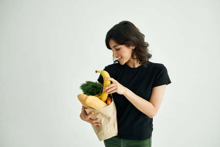 cheerful woman in a black t-shirt food healthy food