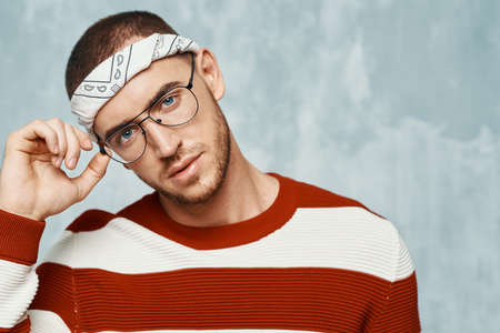 handsome man in striped sweater posing fashion self confidenceの写真素材