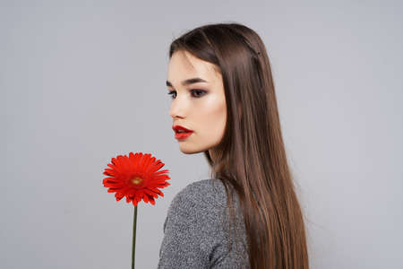 brunette with red flower glamor romance glamorの写真素材