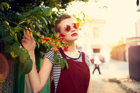 woman wearing sunglasses outdoors flowers decoration summerの写真素材