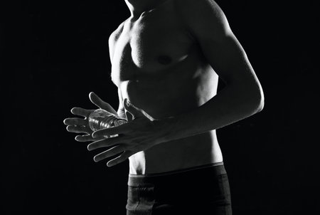 sporty muscular man in black shorts bodybuilder dark backgroundの写真素材