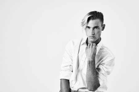 cheerful men in white shirt sitting on a chair posing fashion modern style