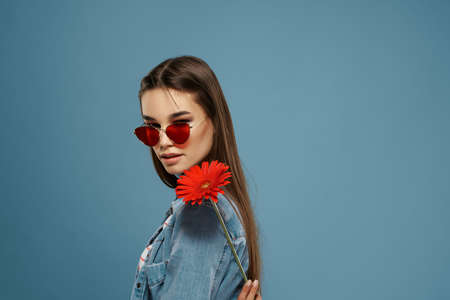 pretty brunette wearing sunglasses red flower elegant style modelの写真素材
