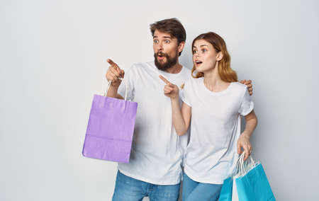 man and woman with packages in hands shopping entertainment lifestyle discount